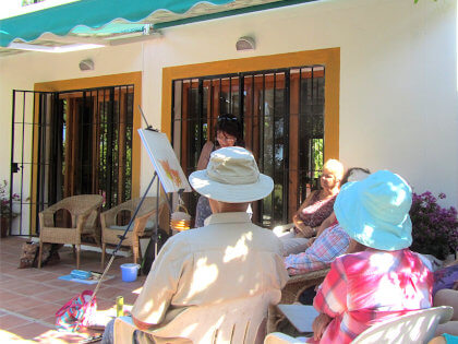 painters with their painting tutor in a lesson